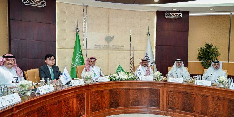 A circular meeting table is displayed in a conference setting, with chairs placed evenly around its perimeter at IAU.