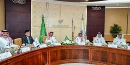 A circular meeting table is displayed in a conference setting, with chairs placed evenly around its perimeter at IAU.